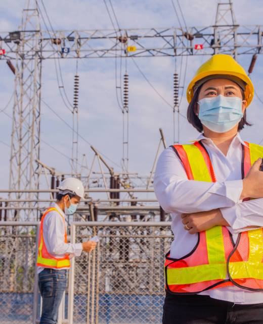 Asian woman Electrician Engineer standing on factory power plant, Portrait Electrician Engineer concept
